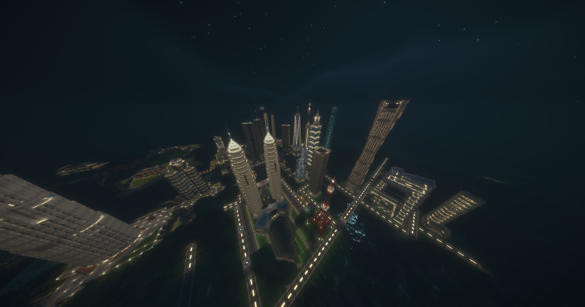 Minecraft screenshot of a city at night with block-built replicas of famous skyscrapers, including twin towers and a red-and-white lattice tower, connected by lit roads